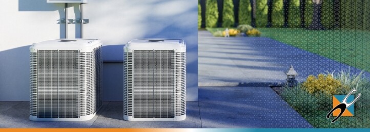 Two outdoor HVAC units beside a house with a landscaped yard, related to furnace installation and air duct repair.